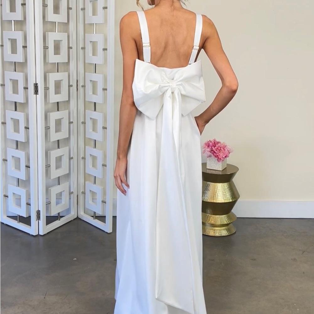 Brand new never worn white dress with cute bow on the back.